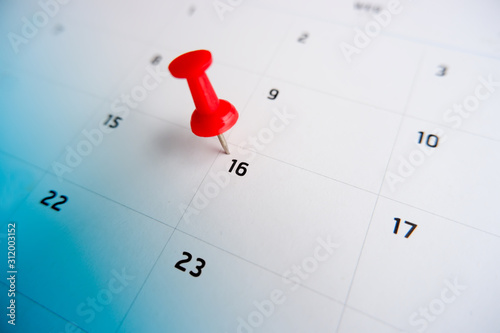 Thumbtack a date on calendar concept for important date, meeting reminder, planning for business, travel planning concept