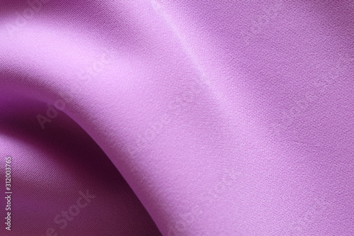 Top view of Beautiful cloth fabric texture background of pastel purple dress. Soft surface detail with wave and motion. Decorative, fashion concept with copy space for text.