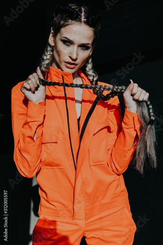 woman with colorful braids in working clothes photo