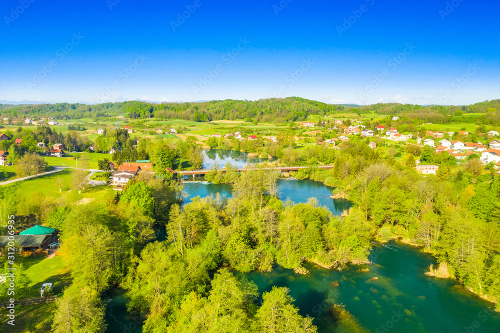 Croatia, beautiful green countryside landscape, Mreznica river from air, aerial drone view of Belavici village and waterfalls in spring