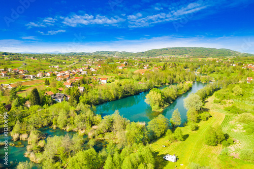 Croatia, beautiful green countryside landscape, Mreznica river from air, aerial drone view of Belavici village and waterfalls in spring