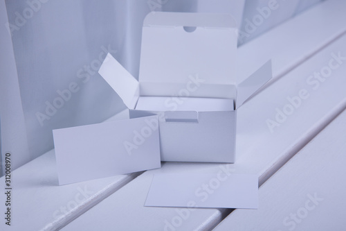 Young woman hand showing blank white bussines card.