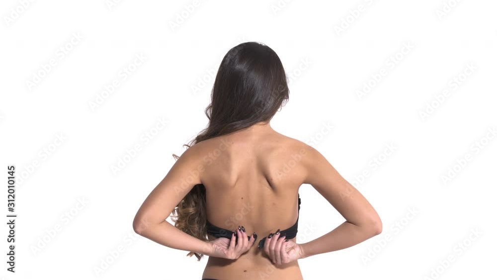 Close-up of woman with long wavy brunette hair taking off her black lingerie. Isolated, on white background Close-up of woman with long wavy brunette hair taking off her black lingerie. Isolated, on white background