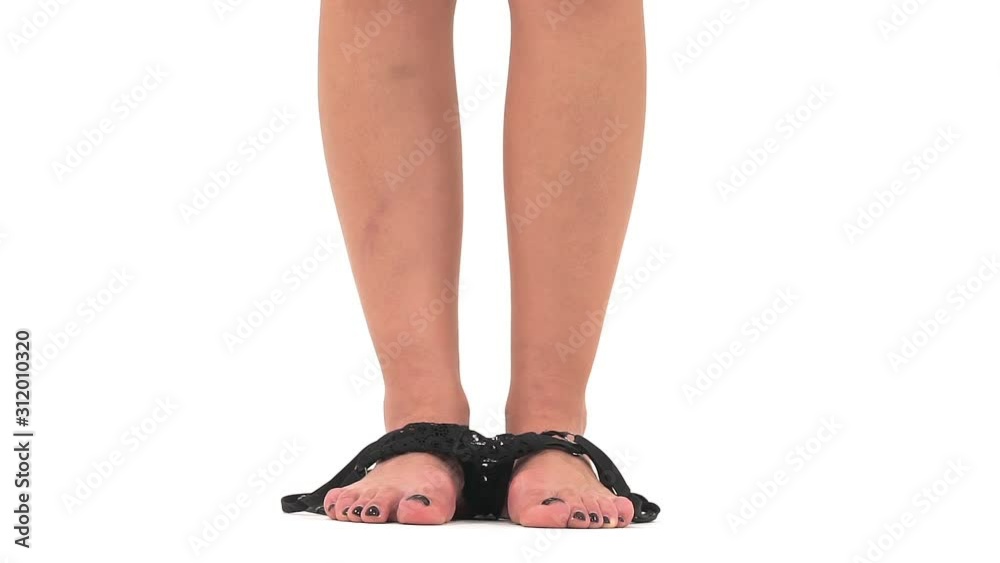 Slow motion of a slim woman getting undress, black lace panties falling on the floor. Isolated, on white background