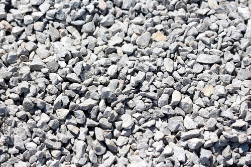 White and grey various sizes gravel at local construction site texture wallpaper background