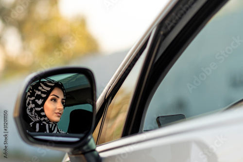 young beautiful muslim woman driving her new car © Aylin