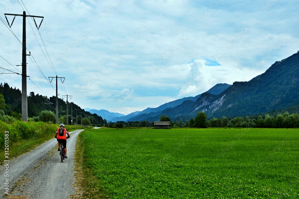 Fototapeta premium Austria- cyclists on the cycle path along the railway