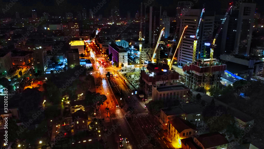 Aerial view on Tel-Aviv. Urban night city never stops. Luxury building and tall towers