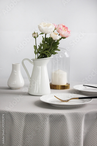  Close-up of flowers in a bright vase on a table with breakfast, bright kitchen interior
