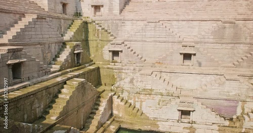 Water storage inside Toorji Ka Jhalra Baoli stepwell - one of water sources in Jodhpur, Rajasthan, India. Vertical pan up to down photo