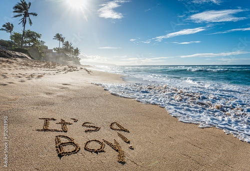 Fototapeta Naklejka Na Ścianę i Meble -  It's a Boy, gender reveal written in the sand on Sunset Beach in Hawaii