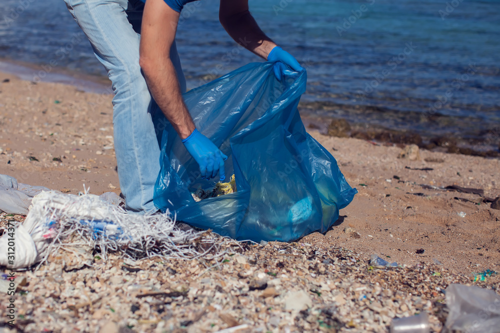 Garbage bags. Blue plastic garbage bags full of trash on the beach