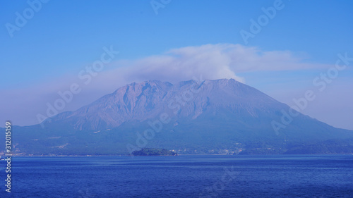 volcano eruption on the japanese islands on a sunny day. an active volcano smokes and throws volcanic dust into the air. Sakurajima volcano