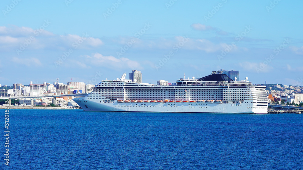 A large luxury cruise ship is moored in the passenger terminal of a modern city. bright white liner in the blue water of the pacific ocean on a sunny day