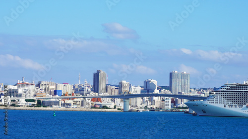 A large luxury cruise ship is moored in the passenger terminal of a modern city. bright white liner in the blue water of the pacific ocean on a sunny day