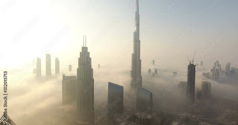 DUBAI, UAE - JANUARY 2, 2017: Aerial view of Burj Khalifa downtown Dubai at sunrise. The Burj al Khalifa is the tallest structure in the world, standing at 829.8 m (2,722 ft). Scenic foggy weather.