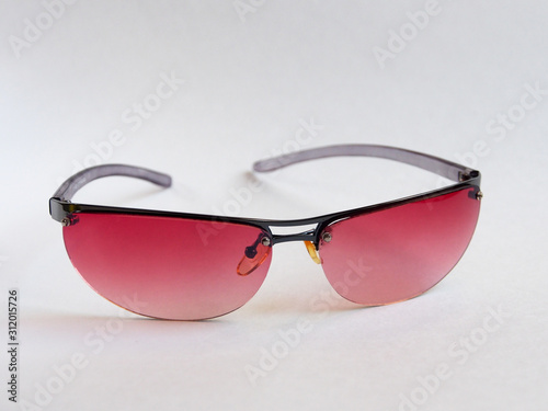 Sunglasses with pink glasses, women's accessory. Summer season, sea, beach.