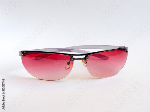 Sunglasses with pink glasses, women's accessory. Summer season, sea, beach.