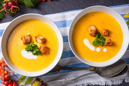 Delicious pumpkin soup with croutons and coconut milk