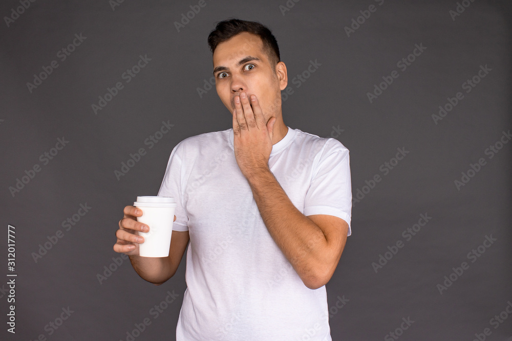 The guy in the white t-shirt admires the coffee and says The guy in the white t-shirt admires the coffee and says