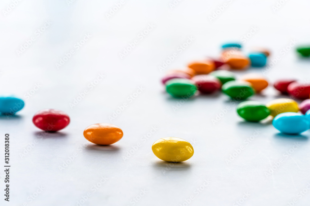 Colorful candy sweets on white background - closeup with selective focus Colorful candy sweets on white background - closeup with selective focus