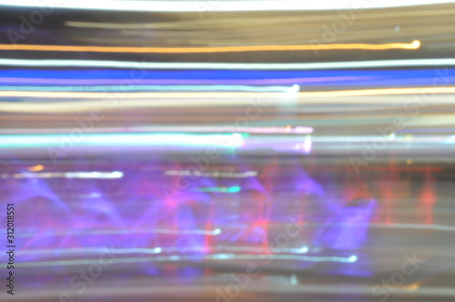 Long exposure photo of a beautiful cityscape. Lights, luminous jets of water left multi-colored luminous stripes