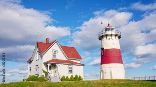 Timelapse of a clouds passing by lighthouse in sunny day in Stratford, USA