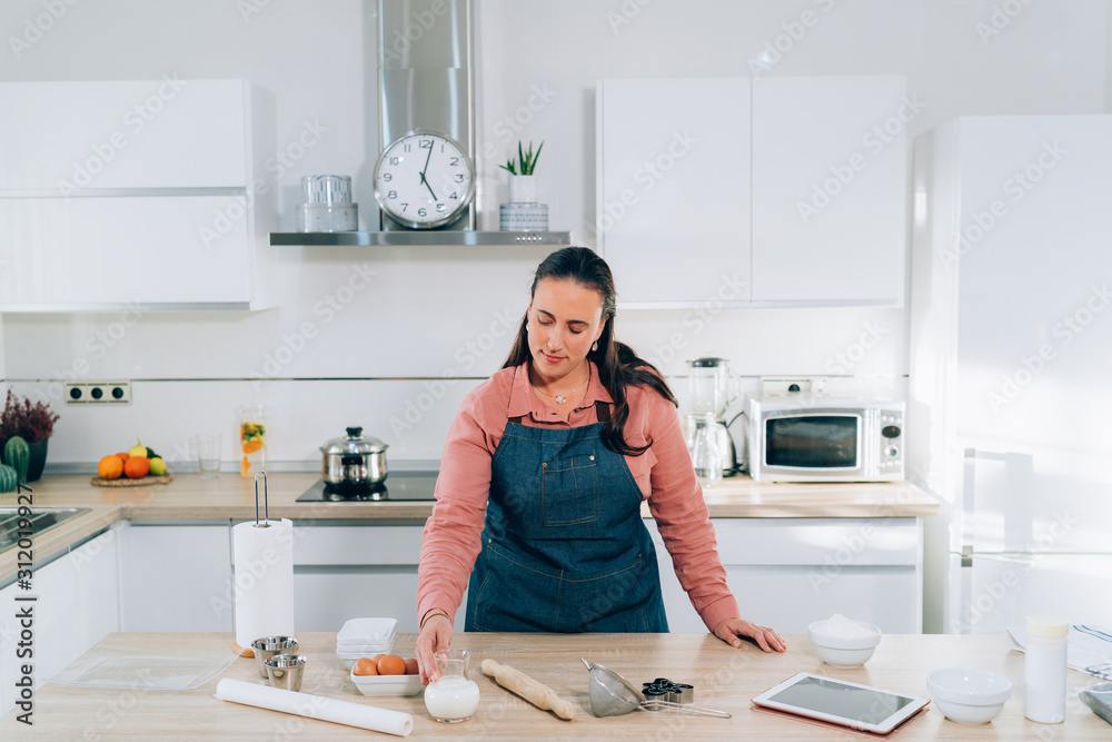Young Woman preparing Christmas cookies at home. Handmade Gingerbread Cookies. Young Woman preparing Christmas cookies at home. Handmade Gingerbread Cookies.