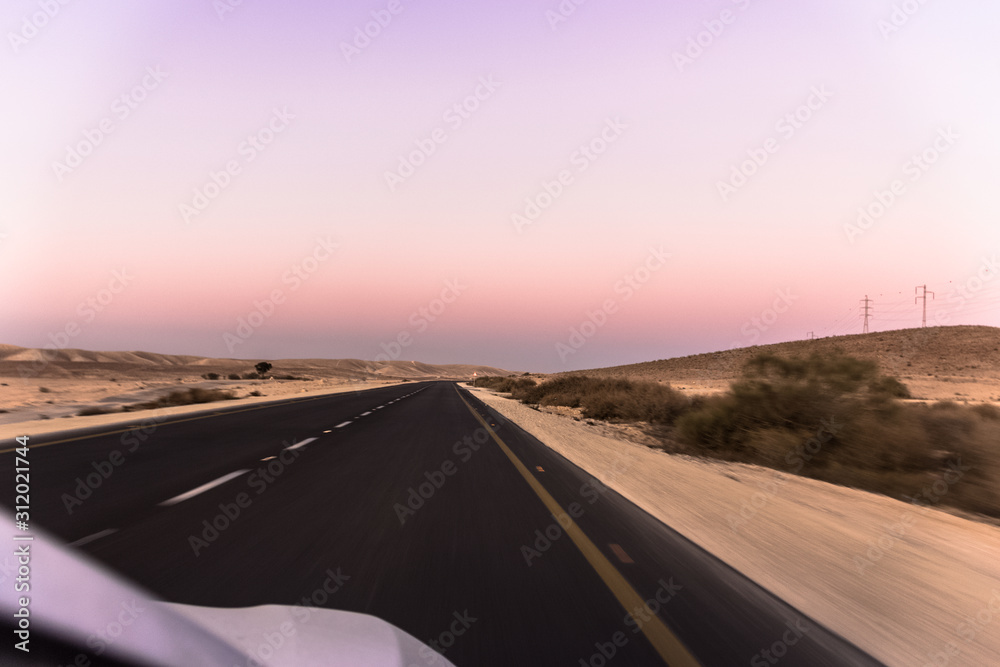 amazing sunset in the desert from the car