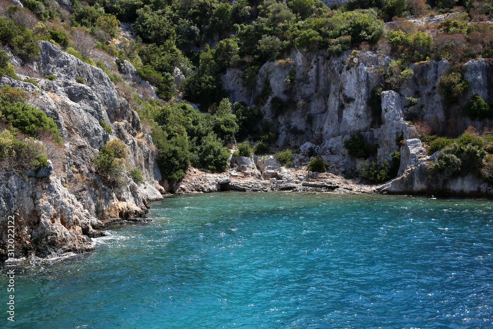 Little blue bay and the rocky coast of Kekova island in Turkey.
