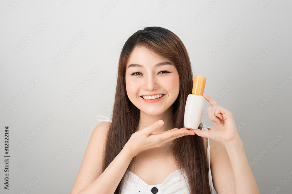 asian woman showing cream on her hand, isolated on white asian woman showing cream on her hand, isolated on white