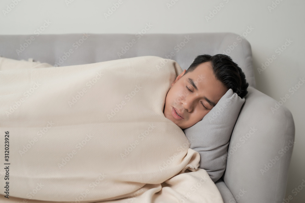 asian eldely sick man feel headache lying on the sofa at home asian eldely sick man feel headache lying on the sofa at home