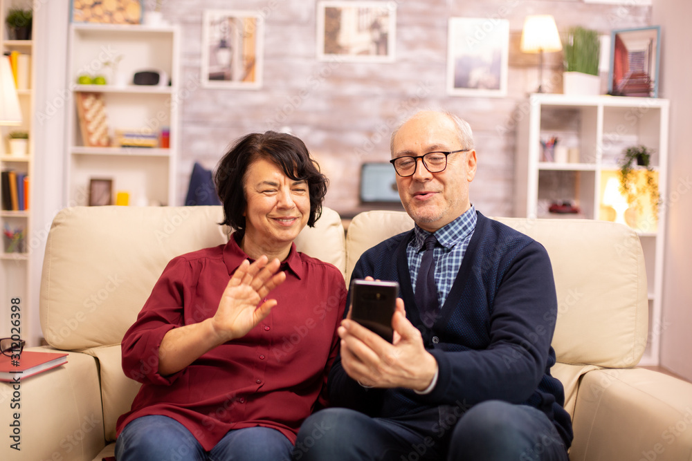 Old eldelry couple using a smartphone to talk with their family Old eldelry couple using a smartphone to talk with their family
