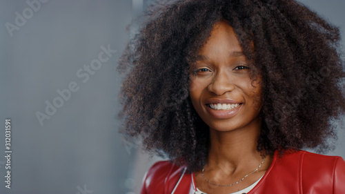 Attractive Black Girl with Lush Curly Hair Posing for a Fashion Magazine Photoshoot. Beautiful Girl Smiles during Professional Studio Photo Shoot for Fashion Magazine. Portrait Shot