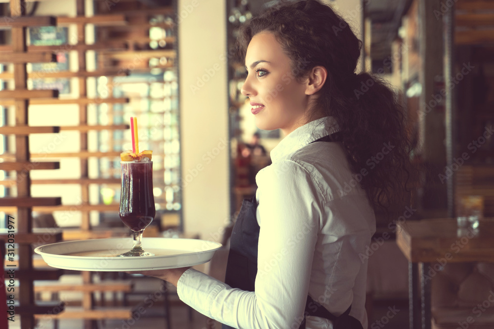 Waitress holding cocktails in a cafe shop Waitress holding cocktails in a cafe shop