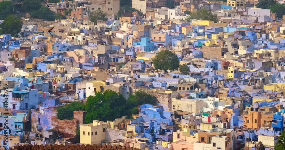 Houses of famous Jodhpur the Blue City, Mehrangarh Fort walls and birds. View from Mehrangarh Fort, Rajasthan, India. Camera zoom out Houses of famous Jodhpur the Blue City, Mehrangarh Fort walls and birds. View from Mehrangarh Fort, Rajasthan, India. Camera zoom out