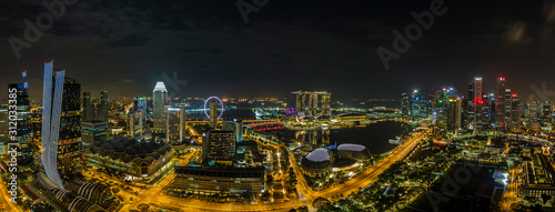 Aerial panoramic picture of Singapore skyline and gardens by the bay during preparation for Formula 1 race in the night in autumn