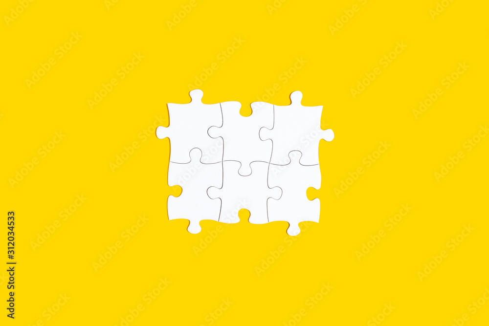 White puzzle with copy space isolated on yellow background White puzzle with copy space isolated on yellow background