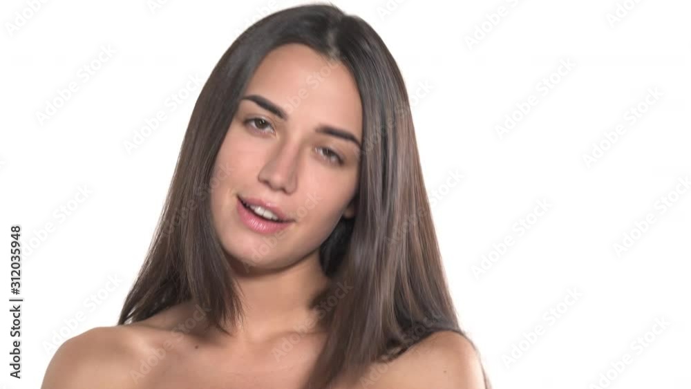 Sexy young woman with naked shoulders touching her face and gorgeous hair while posing to the camera. Beauty concept Sexy young woman with naked shoulders touching her face and gorgeous hair while posing to the camera. Beauty concept