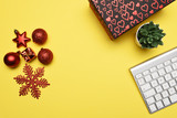 Christmas decoration with computer keyboard on the yellow background with copy space
