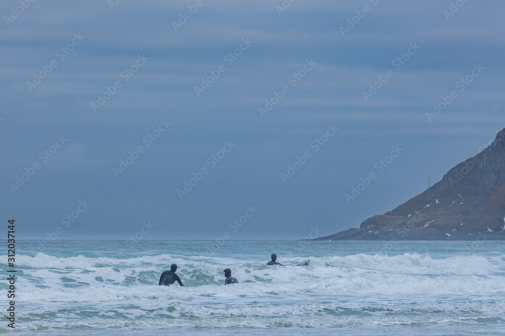 Fototapeta premium Winter surfers in Lofoten islands in Norway