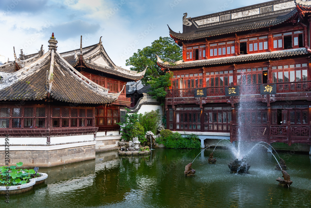 Water fountain and beautiful, traditional red buildings in Yuyuan Old Street in Shanghai, China Water fountain and beautiful, traditional red buildings in Yuyuan Old Street in Shanghai, China