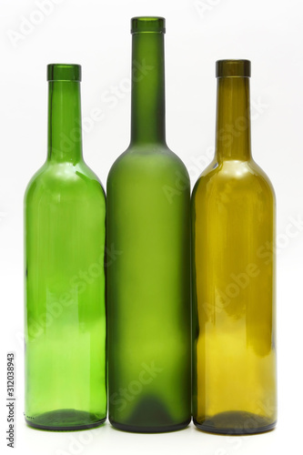 three empty bottles of wine on white background