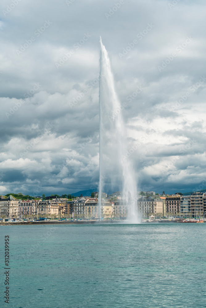 Geneva's main monument and landmark, the Jet d'Eau (Water Jet), taken in a spring in cloudy day.