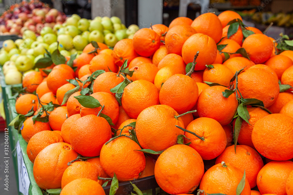 Fresh oranges, fruits and vegetables at market in boxes