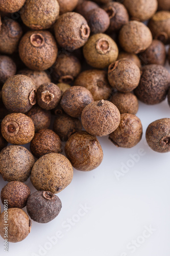 fresh spicy peppers allspice on white acrylic background