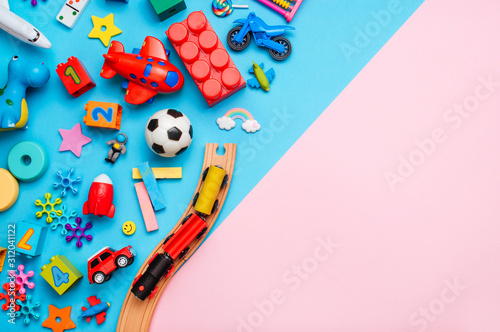 Frame of kids toys on color block pink and blue background