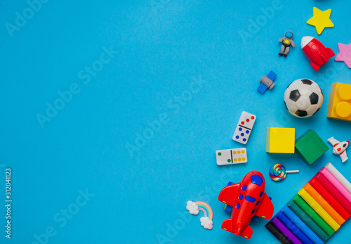 Frame of kids toys on blue background with copy space