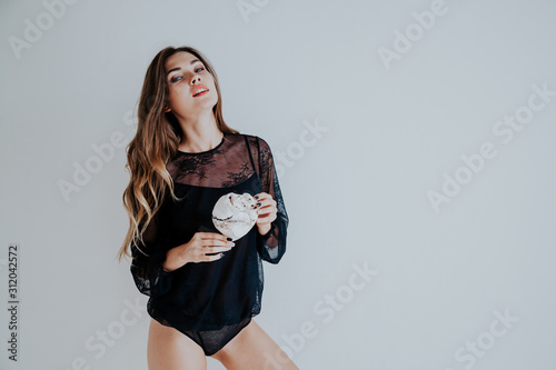 beautiful woman in underwear with a sweet cake in hand photo