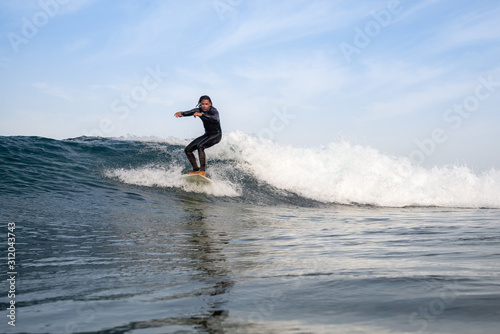 surfer riding waves on the island of fuerteventura © Simone Tognon